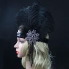 Roaring Twenties flapper accessory with layered black feathers in fan arrangement