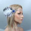 Close-up of blue rhinestone sunburst brooch with black-tipped ostrich feathers