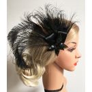 Close-up of sequined black flower appliqué and iridescent peacock feather pattern on vintage fascinator