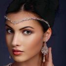 Silver crystal forehead chain with teardrop centerpiece on model with updo hairstyle