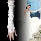Long fingerless bridal gloves with ornate floral lace detail at wrist opening