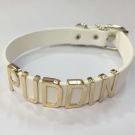 White faux leather choker with gold nickname letters and buckle closure
