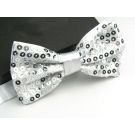 Close-up of alternating white and silver faceted sequins on bow tie surface