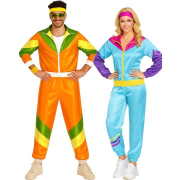 Adult couple wearing matching 80s shell suit costumes in bold color-block panels
