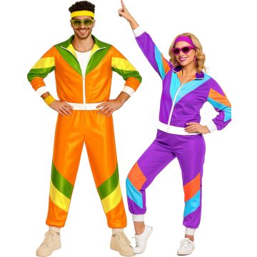 Adult couple wearing matching 80s shell suits with bold colour-blocking and shiny finish