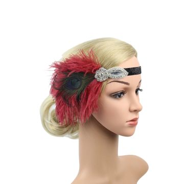 Burgundy feather headband with peacock eye and rhinestone brooch worn across forehead