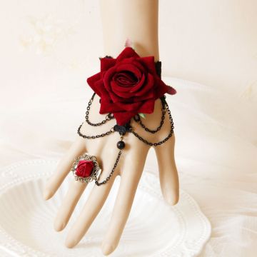 Three-strand bronze chain drape connecting Gothic lace bracelet to ornate filigree ring with rose cabochon