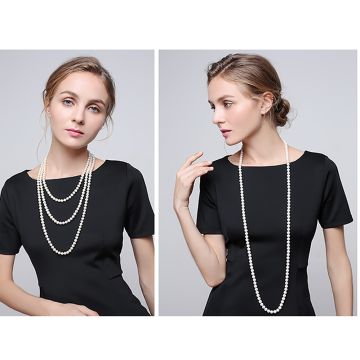 Long cream pearl necklace strand worn triple-looped around neck in 1920s flapper style