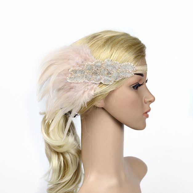 Close-up of hand-sewn rhinestone scrollwork centerpiece with natural rooster feather plume on vintage headband Close-up of hand-sewn rhinestone scrollwork centerpiece with natural rooster feather plume on vintage headband