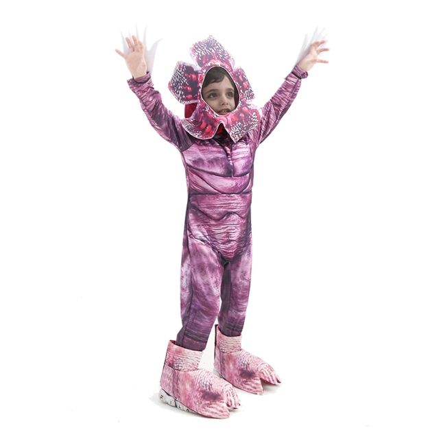 Child wearing full-body creature jumpsuit with dimensional spotted headpiece and gradient scale print Child wearing full-body creature jumpsuit with dimensional spotted headpiece and gradient scale print
